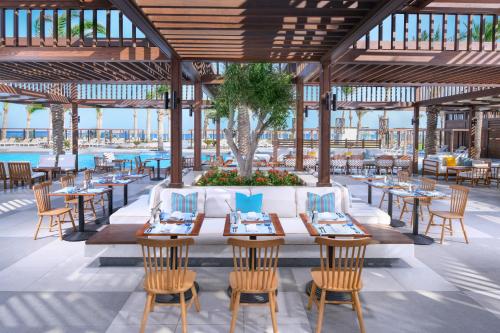 an outdoor dining area with tables and chairs at JAZ Costa Mares in Marsa Alam City
