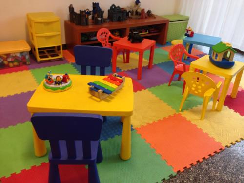 a classroom with colorful chairs and a table and chairs at Hotel Mare in Pesaro