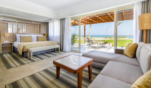 a living room with a bed and a couch at JAZ Costa Mares in Marsa Alam City