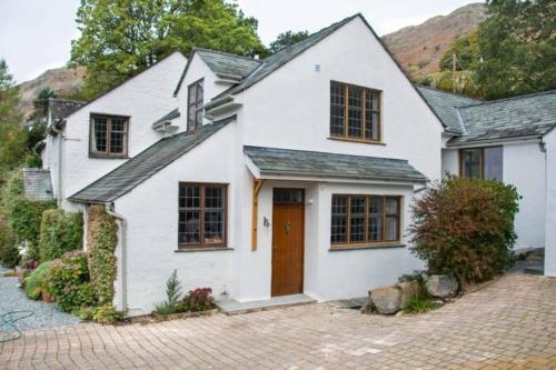 a white house with a brick driveway at Heron Place, Great Langdale in Ambleside