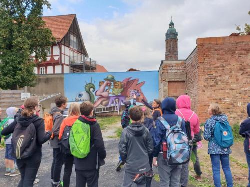 a group of people standing in front of a mural at Fachwerk-Kultur-Pension TangoBrücke in Einbeck