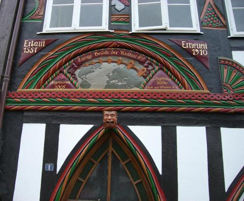 a building with a clock on the side of it at Fachwerk-Kultur-Pension TangoBrücke in Einbeck