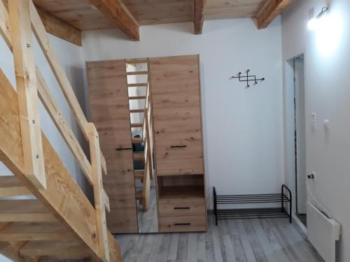 a staircase in a room with a wooden door at Ruza vetrova in Divčibare