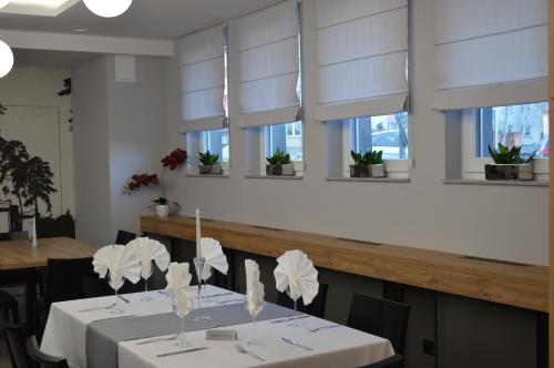 a dining room with white blinds on the windows at Hotel Stal in Stalowa Wola