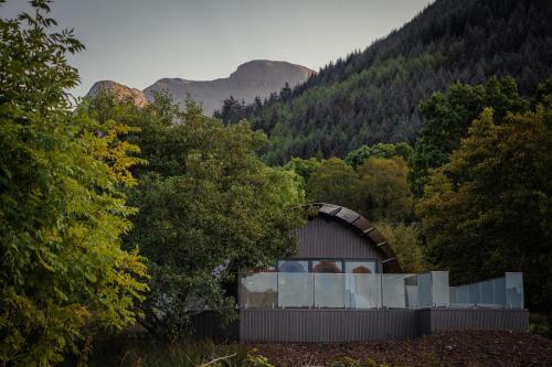 a small building in the middle of a forest at SeaBeds - Luxury Lookouts with Hot Tubs in Glencoe