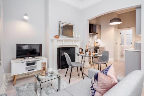 a living room with a couch and a table at Stay Kula London - Covent Garden St Martin's Lane in London
