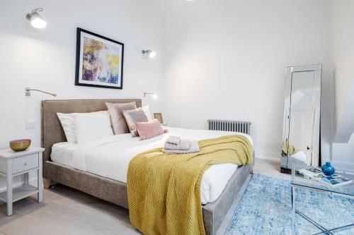 a bedroom with a large bed and a mirror at Stay Kula London - Covent Garden St Martin's Lane in London