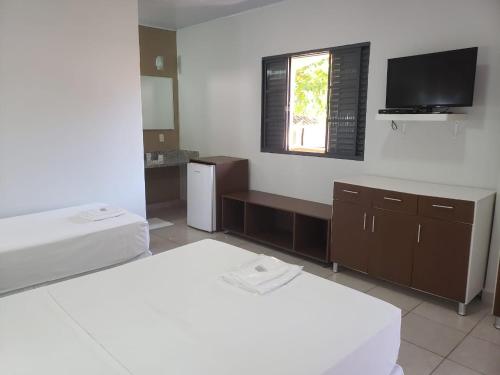 Säng eller sängar i ett rum på Pantanal Hotel