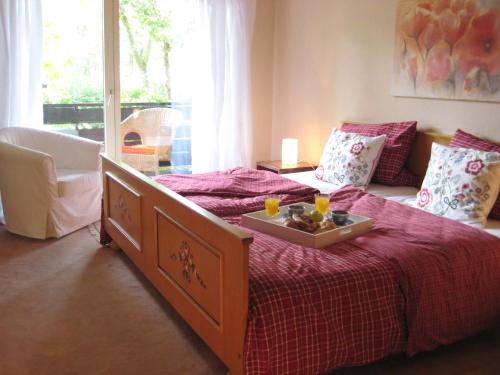 a bedroom with a bed with a tray of food on it at Haus an der Therme in Bad Endorf