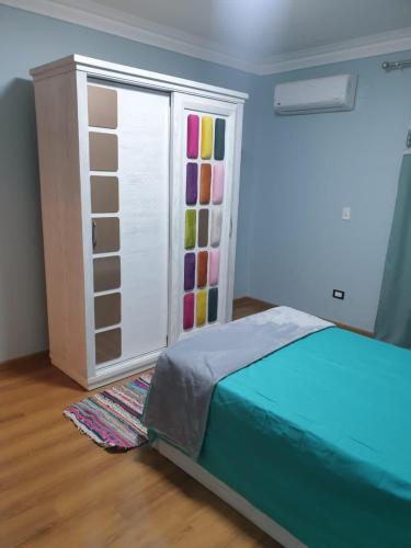 a bedroom with a bed and a sliding door at New Apartment AlMohandessin near Shehab street in Cairo
