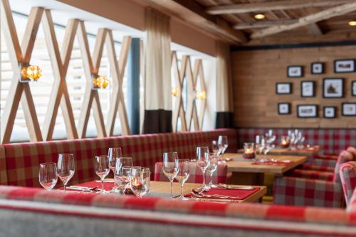 a row of wine glasses on a table in a restaurant at Superior Hotel Edelweiss in Obertauern