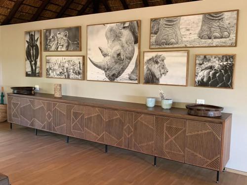a wooden cabinet with drawings of animals on a wall at Laluka Safari Lodge - Welgevonden Game Reserve in Welgevonden Game Reserve
