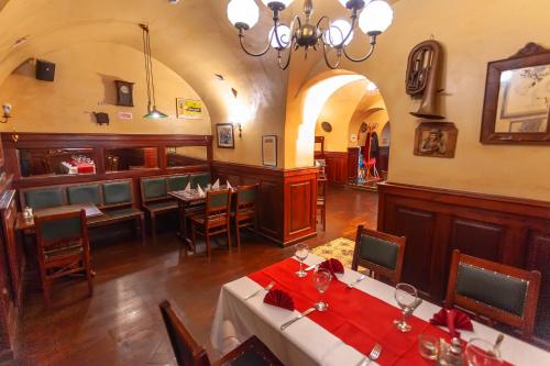 a restaurant with a dining room with tables and chairs at Belga Boutique Panzió in Debrecen