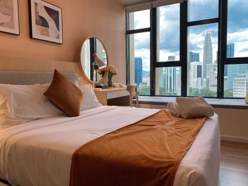 a bedroom with a large bed with a view of a city at Ceylonz Starlight Suites Bukit Bintang in Kuala Lumpur