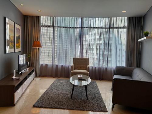 a living room with a couch and a table at Vortex Suites KLCC by Sayang in Kuala Lumpur