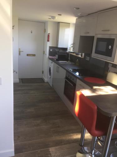 a kitchen with a sink and a stove top oven at Cosy sea view cottage Isle of Skye in Colbost