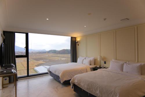 Postel nebo postele na pokoji v ubytování Suncheon Hotel Gite