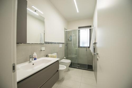 a bathroom with a sink and a toilet and a shower at Home Square in Milazzo