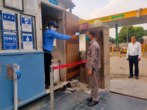 two men are standing at a gas station at Fortune District Centre, Ghaziabad - Member ITC Hotels' Group in Ghaziabad