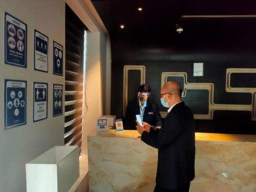 two men in suits standing in front of a counter at Fortune District Centre, Ghaziabad - Member ITC Hotels' Group in Ghaziabad