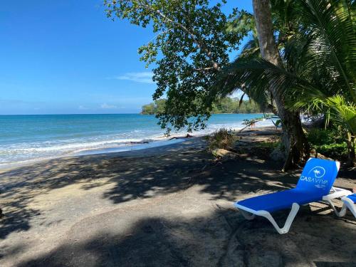 two blue chairs sitting on a beach near the ocean at Casa Viva Eco Lodge in Puerto Viejo