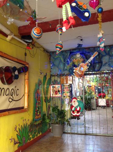 a room filled with lots of decorations on a wall at Hostal Oaxaca Magic in Oaxaca City