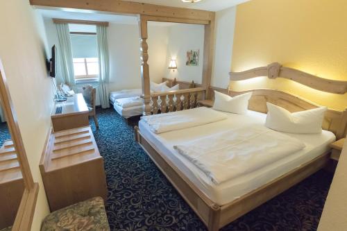 a hotel room with two beds and a mirror at Hotel Löwen in Randersacker