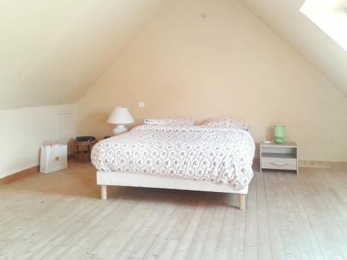 a bedroom with a bed in a attic at Maison d'une chambre avec jardin amenage et wifi a Plehedel a 5 km de la plage in Pléhédel