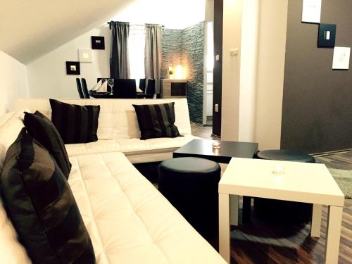 a living room with a couch and a table at Charming Apartment in Rakovica with Shared Pool in Oštarski Stanovi