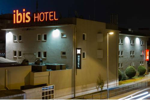 a hotel with a sign on the side of a building at Hotel ibis Guimaraes in Guimarães
