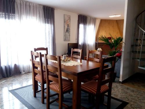 a dining room with a wooden table and chairs at Spacious House in Deltebre with Terrace in Deltebre