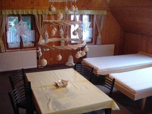 a dining room with a table and a table and chairs at Chata Bucharka in Liberec