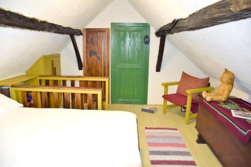 a bedroom with a bed and a green door at Cosy Chalet in Gospić with Jacuzzi and Mountain View in Gospić