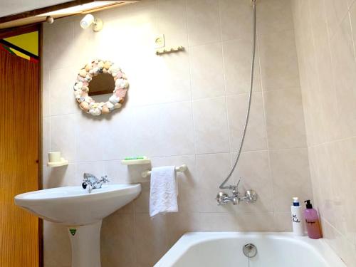 a bathroom with a sink and a bath tub at Charming house with mountain view in Manteigas, fireplace in Manteigas