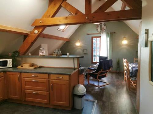 a kitchen with wooden cabinets and a dining room at Chalet de 3 chambres avec sauna et wifi a Arrens Marsous in Arrens-Marsous