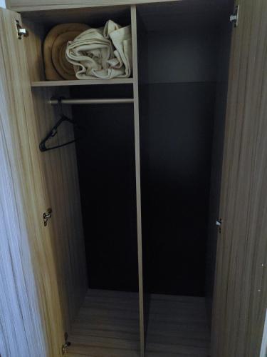 a closet with a door open with a pile of clothes at Exchange Club Motel in Beatty