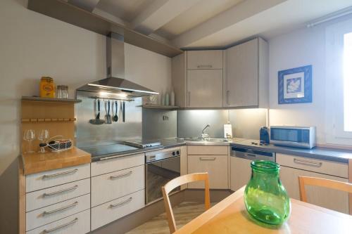 a kitchen with a table and a vase on the table at Refined Apartment in Lastra a Signa - 77 sqm - Air Conditioning in Lastra a Signa
