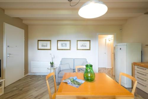a kitchen with a table with a green vase on it at Refined Apartment in Lastra a Signa - 77 sqm - Air Conditioning in Lastra a Signa