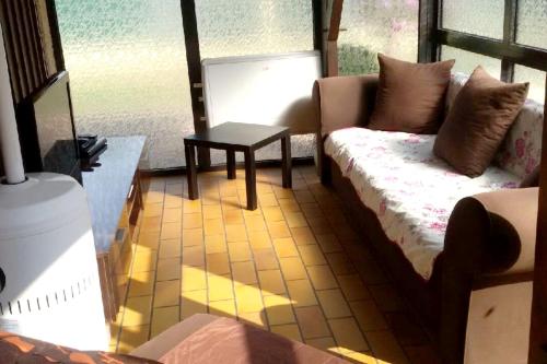 a living room with a couch and a table at Villa en pleine nature à Escource avec piscine privée in Escource
