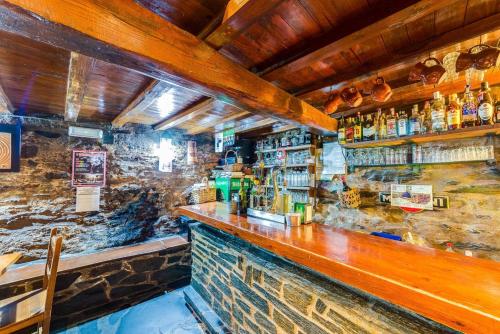 a bar with a wooden counter in a room at Studio with balcony and wifi at Robledillo de Gata in Robledillo de Gata