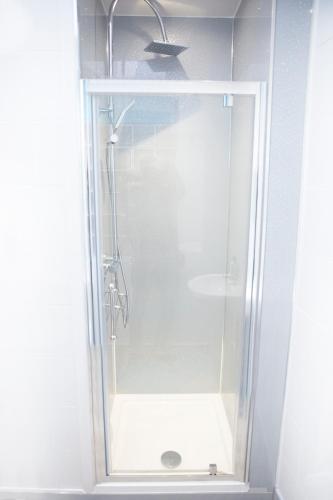 a shower with a glass door in a bathroom at The Neuk Anstruther - Sleeps 6 - Dogs Welcome in Anstruther