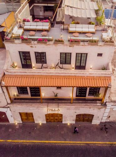 an overhead view of a building with a person sitting on the street at Palla Boutique Hotel in Arequipa