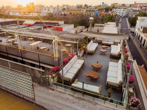 a balcony with chairs and tables on a building at Palla Boutique Hotel in Arequipa