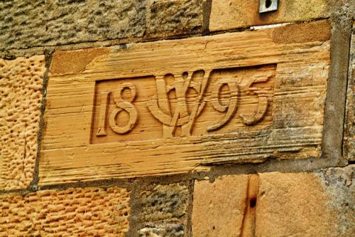 a sign on the side of a brick building at Stotfield Hotel in Lossiemouth