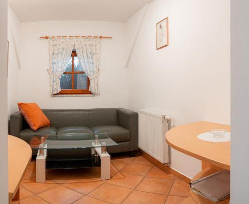 a living room with a couch and a table at Hotel Gostilna Vovko in Novo Mesto