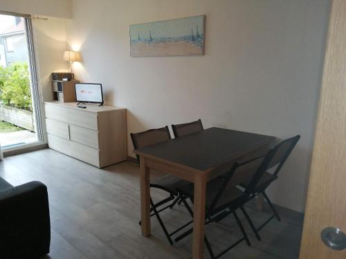 une salle à manger avec une table et des chaises dans une pièce dans l'établissement les voiliers, à Le Touquet-Paris-Plage