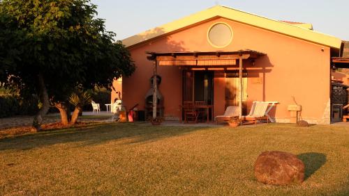 a house with a rock in front of it at Roccabianca in Sorso