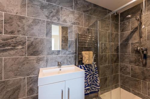 a bathroom with a sink and a shower at Stunning Shore Front house in historic Cellardyke in Anstruther