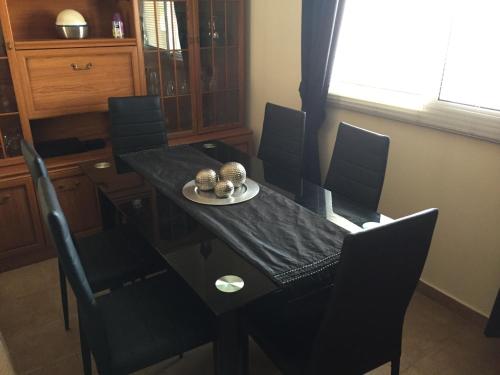 a dining room table with black chairs and a black table and chairsktop at Beautiful spacious 2-Bed Apartment in Xylofagou in Xylophaghou