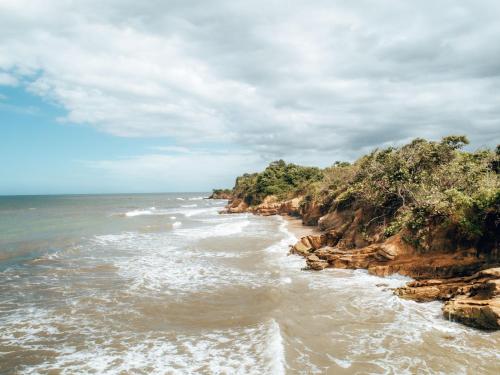 a view of the ocean from a rocky beach at Casa Chapolin Boutique Guesthouse in Palomino